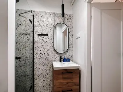 a bathroom with a sink and a mirror at Sunset Stories Old Town Apartment in Kraków