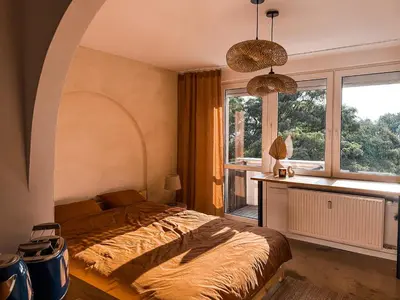 a bedroom with a bed and a window at Sunset Stories Old Town Apartment in Kraków