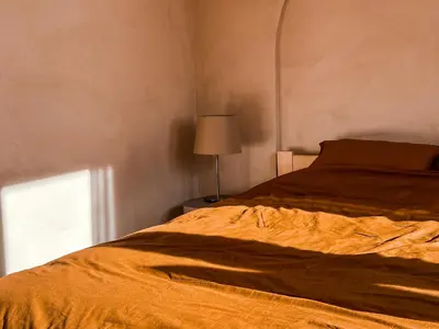 a bedroom with a bed and a lamp and a window at Sunset Stories Old Town Apartment in Kraków