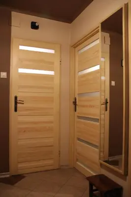 a room with wooden doors in a house at Apartment Widok in Kraków
