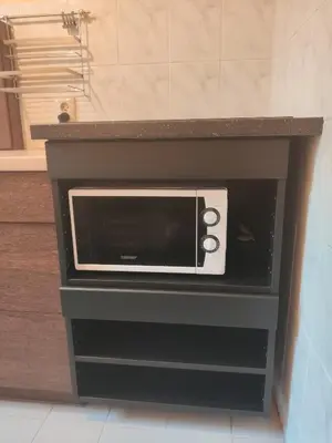 a microwave oven sitting inside of a counter at Apartment Widok in Kraków