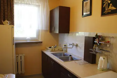 a kitchen with a sink and a window at Apartment Widok in Kraków