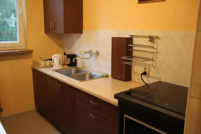 a kitchen with a sink and a counter top at Apartment Widok in Kraków