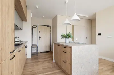 a kitchen with a island in the middle of a room at Tauron Arena Crakow Apartment with Parking by Noclegi Renters in Kraków
