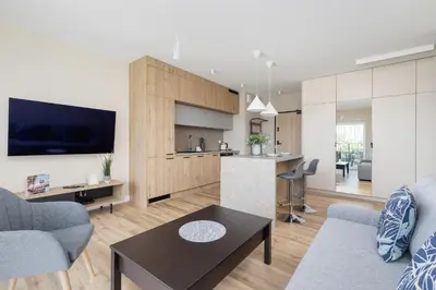 a living room with a couch and a table at Tauron Arena Crakow Apartment with Parking by Noclegi Renters in Kraków