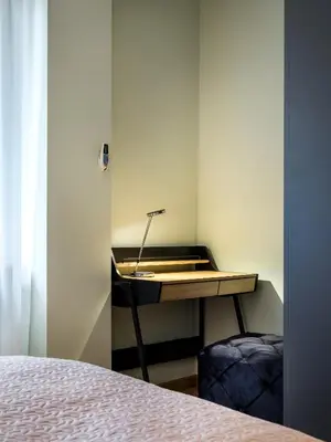 a desk in a room with a bed at Tyzenhauz Apartments Pawia Street in Kraków