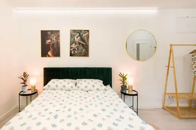 a bedroom with a bed and a mirror on the wall at Cosy and Stylish apartment in Kraków