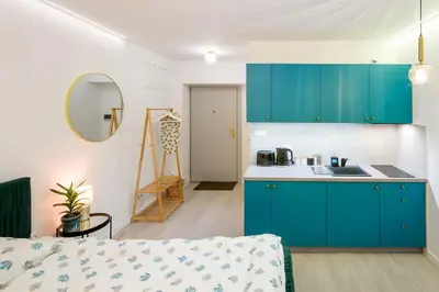 a kitchen with blue cabinets and a counter top at Cosy and Stylish apartment in Kraków