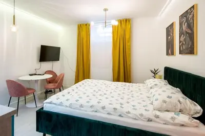 a bedroom with a bed and a table and chairs at Cosy and Stylish apartment in Kraków