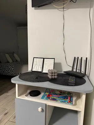 a white table with a table with a blackussion at Apartament Guziczek in Nowy Targ