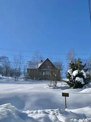 a house in a field covered in snow at Apartament Guziczek in Nowy Targ