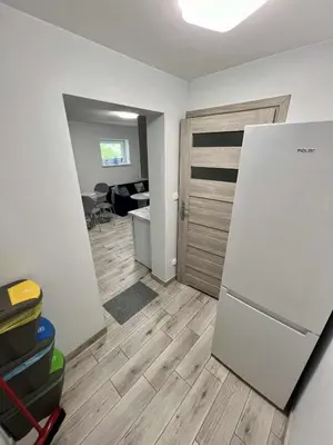 an empty room with a refrigerator and a desk at Apartament Guziczek in Nowy Targ