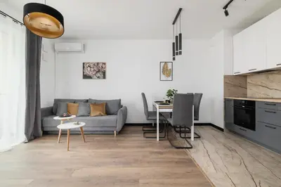 a living room with a couch and a table at Kopiec Kraka Podgórze with Parking by Noclegi Renters in Kraków