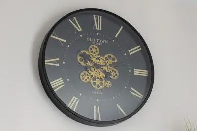 a black clock with gold gears on a wall at Kopiec Kraka Podgórze with Parking by Noclegi Renters in Kraków