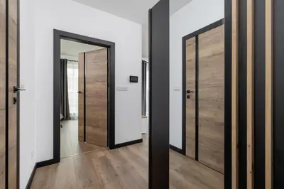 a hallway with two doors and a mirror at Kopiec Kraka Podgórze with Parking by Noclegi Renters in Kraków