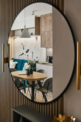 a dining room with a table in a mirror at Golden Dreams Luxury Apartment 81 in Kraków