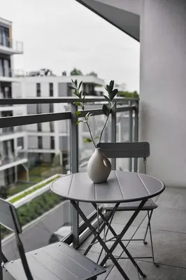 a vase sitting on top of a table on a balcony at Golden Dreams Luxury Apartment 81 in Kraków