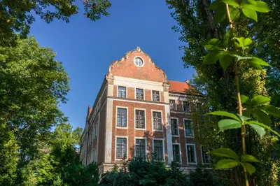 an old brick building with a red roof at Dom Profesorski im. Stanisława Pigonia in Kraków