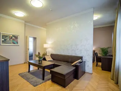 a living room with a couch and a table at Dom Profesorski im. Stanisława Pigonia in Kraków