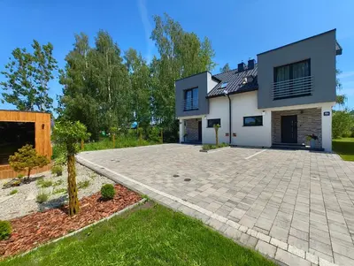 a house with a driveway in front of it at Domek Niebieskie Marzenie in Chrzanów