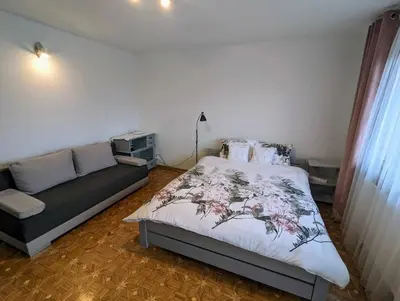 a bedroom with a bed and a couch at Guest House close to Molo Resort in Osiek
