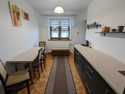 a kitchen with a table and chairs and a dining room at Guest House close to Molo Resort in Osiek
