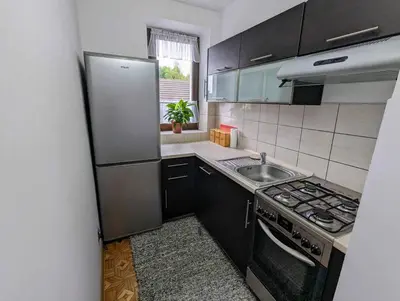 a kitchen with a stainless steel refrigerator and a sink at Guest House close to Molo Resort in Osiek