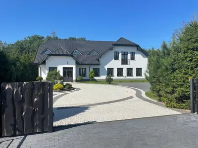 a large white house with a winding driveway at Zakątek przy lesie in Łętowice