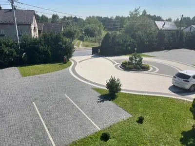 a winding road with a car parked in a driveway at Zakątek przy lesie in Łętowice