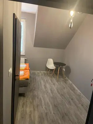 a room with a bed and a table and a table at Zakątek przy lesie in Łętowice