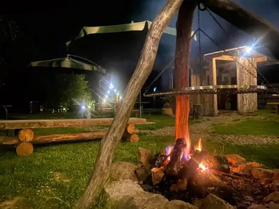 a person standing over a fire in a field at night at Biwak u Gazdy in Gosprzydowa