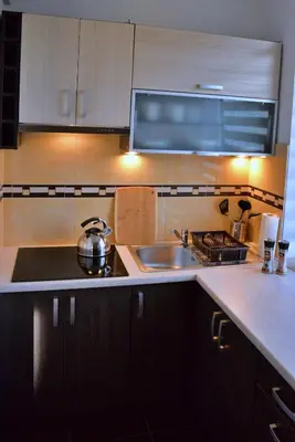 a kitchen with a sink and a stove at Ring Apartments - Kraków in Kraków