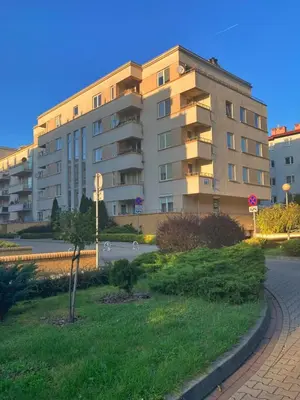 a large apartment building in front of a building at Ring Apartments - Kraków in Kraków