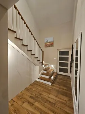 a staircase in a house with wooden floors at Dom na Partykowie in Budzów