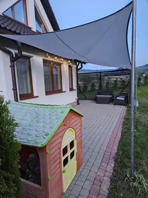 a dog house with a canopy on a patio at Dom na Partykowie in Budzów