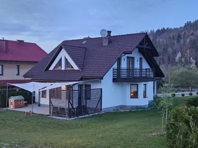 a white house with a black roof at Dom na Partykowie in Budzów