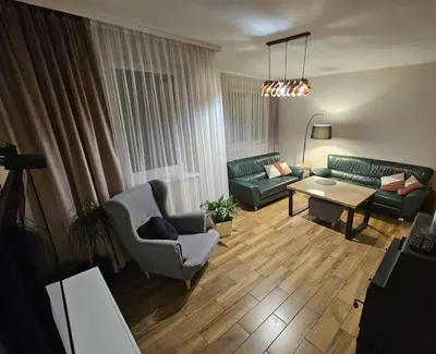 a living room with couches and a table and a couch at Dom na Partykowie in Budzów