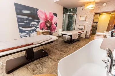 a bathroom with a sink and a bath tub at Hotel Olivia Medical SPA in Skomielna Czarna