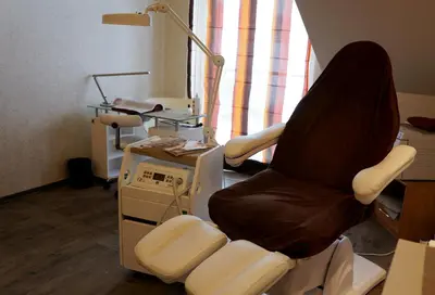 a chair in a room with a lamp and a machine at Hotel Olivia Medical SPA in Skomielna Czarna