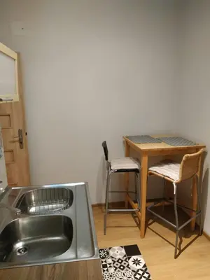 a kitchen with a table and a table and chairs at FEIDUM quarters flat in Kraków
