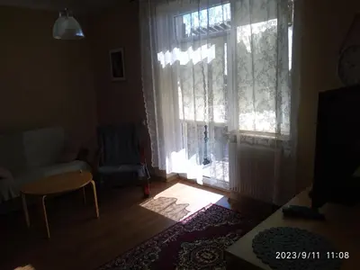 a living room with a window and a chair at FEIDUM quarters flat in Kraków
