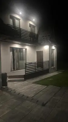 a house at night with a bench in front of it at Willa Na Bystrej - Całoroczny dom na wynajem in Rabka-Zdroj
