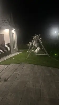 a swing set in the yard of a house at night at Willa Na Bystrej - Całoroczny dom na wynajem in Rabka-Zdroj