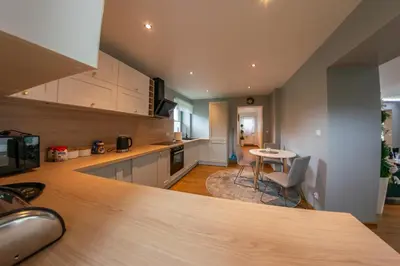 a kitchen with a counter top and a table at Willa Na Bystrej - Całoroczny dom na wynajem in Rabka-Zdroj
