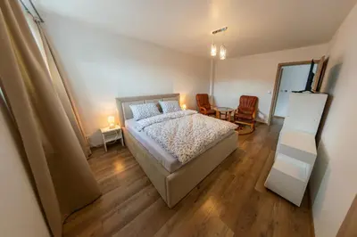 a bedroom with a bed and a table and chairs at Willa Na Bystrej - Całoroczny dom na wynajem in Rabka-Zdroj