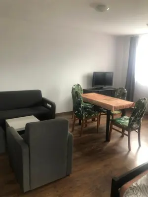 a living room with a wooden table and chairs at Amla in Biadoliny Radłowskie