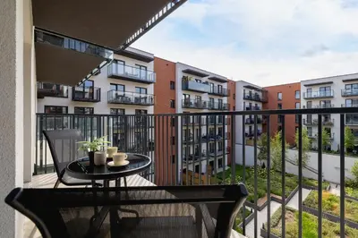 a balcony with a table and some buildings at Beautiful Apartment Klimeckiego with balcony by Noclegi Renters in Kraków