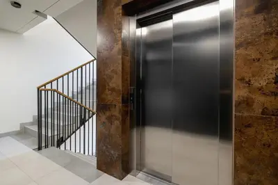 a metal elevator in a hallway with a staircase at Beautiful Apartment Klimeckiego with balcony by Noclegi Renters in Kraków
