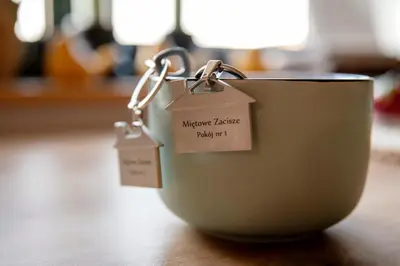 a cup with tags on it sitting on a table at Miętowe Zacisze Zator in Laskowa