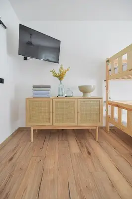 a living room with a tv on a wall at Miętowe Zacisze Zator in Laskowa